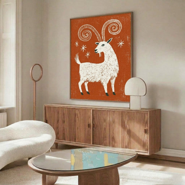 Japandi-inspired linocut artwork depicting a whimsical goat with ornamental spiral horns and celestial stars in earthy rust and deep teal hues.