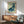 Playful vintage whale with festive party hat and starry elements in a dreamy color palette of sage green and navy, displayed as a framed minimalist poster.