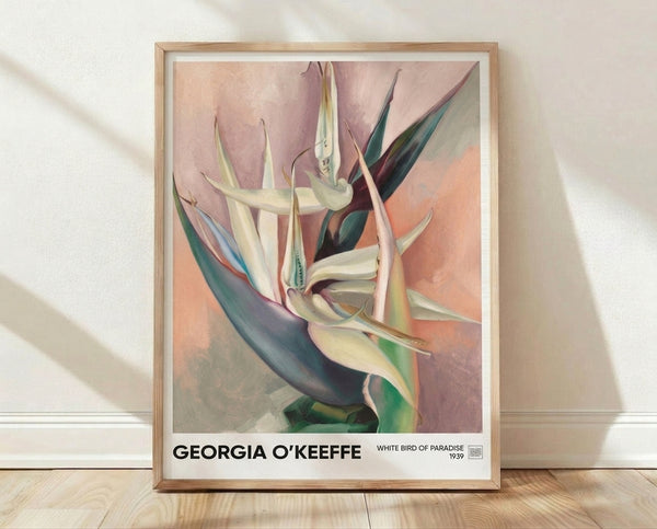 Framed watercolor art print of a pale cream and rose bird of paradise flower with deep teal and sage accents, evoking sensual elegance and contemplative beauty on a gallery wall.