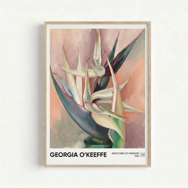 Soft watercolor painting of a white bird of paradise bloom in muted dusty rose and cream tones with teal highlights, displayed as a framed poster in an elegant interior setting.