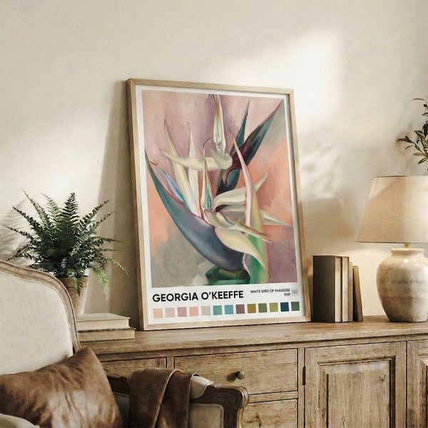 Framed watercolor painting of a pale cream and rose-toned bird of paradise flower with deep teal and sage details, capturing contemplative botanical elegance.