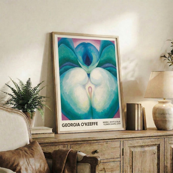 Framed abstract poster displaying layered organic petal and stamen forms in cool palette of deep blue and cream, capturing the meditative quality of early twentieth-century botanical modernism.