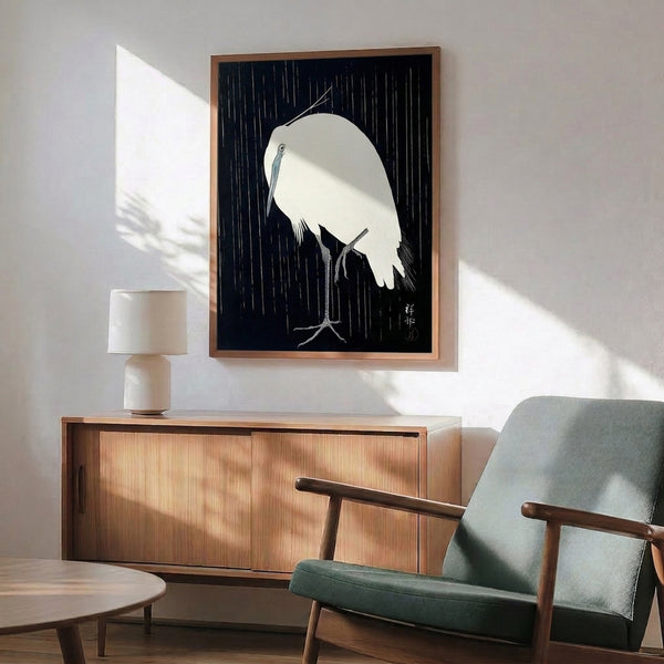 Navy and white framed art print of a tranquil crane in falling rain, combining Japanese woodblock tradition with minimalist line art sensibility.