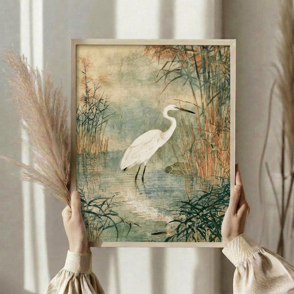 Vintage-style watercolor artwork depicting a graceful heron in a wetland setting with muted cream, brown, and green hues, displayed as a framed print.