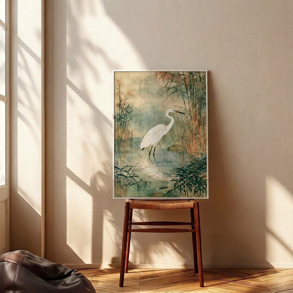 Contemplative watercolor scene of an egret amid reeds and shallow water rendered in soft, naturalistic tones of sage and dusty blue, presented as framed wall decor.