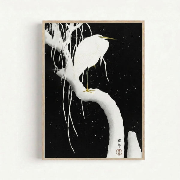Japandi wall art featuring an elegant egret in snow, depicted in traditional woodblock technique with cream and black tones, winter branches, and delicate gold accents creating a peaceful nocturnal scene.