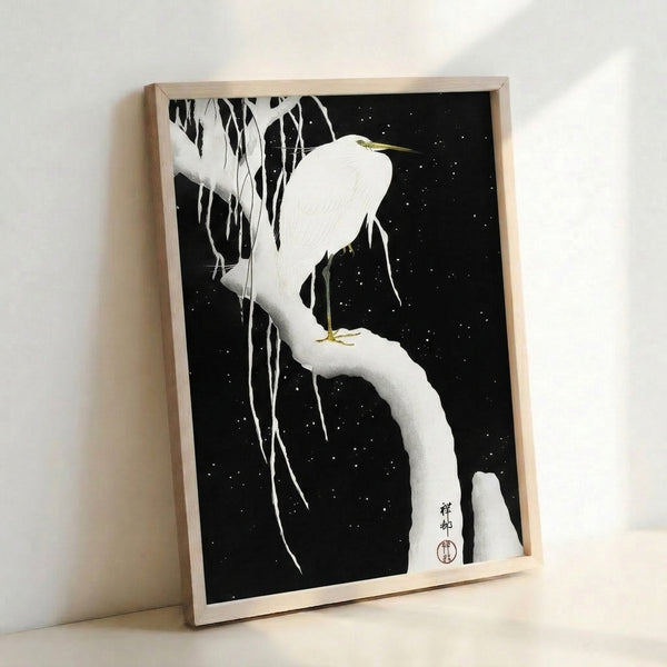 Minimalist Japanese egret print in white and gold on dark background, showing the bird resting on a frost-laden branch with icicles and starlight, framed for zen home décor.