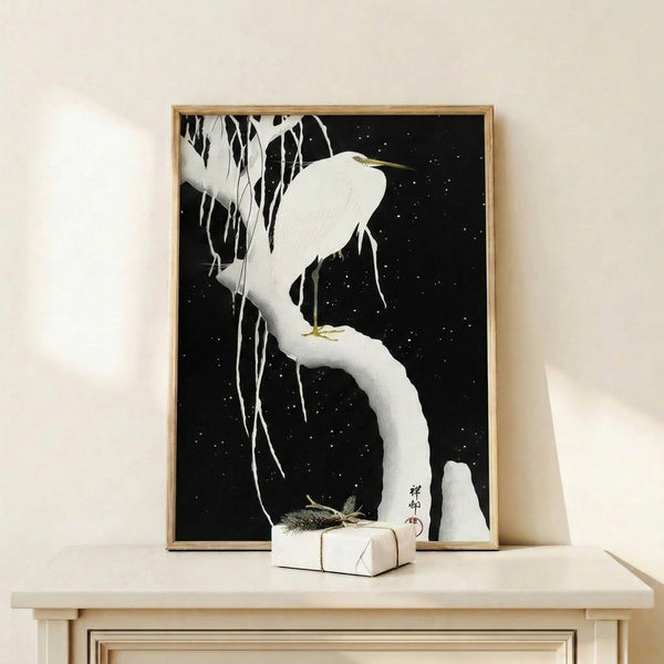 Serene woodblock-style poster of a white egret amid falling snow and hanging ice crystals on a branch, with scattered gold stars on black, evoking quiet winter contemplation.