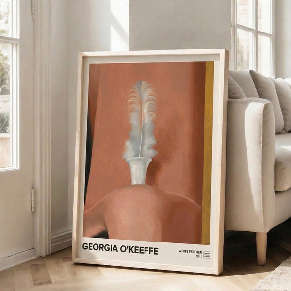 Sensual botanical-inspired artwork featuring a white feather with flowing organic shapes in cream, gold, and terracotta tones, displayed as a framed wall print.