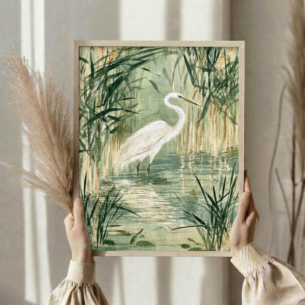 Framed watercolor art print depicting a great egret in a tranquil reed bed with soft cream, sage, and tan hues, capturing a zen-like peaceful wetland atmosphere.