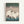 Minimalist Japandi poster depicting graceful cranes in winter snow, featuring a contemplative composition in muted whites, greens, and cool blue hues on a gallery wall.