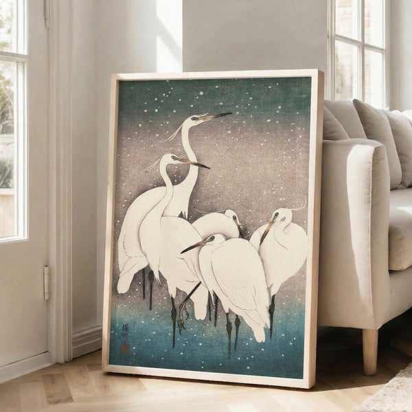 Japanese-inspired minimalist print of cranes in winter snow, evoking wintry grace through soft whites, teal blue, sage green, and slate gray tones.