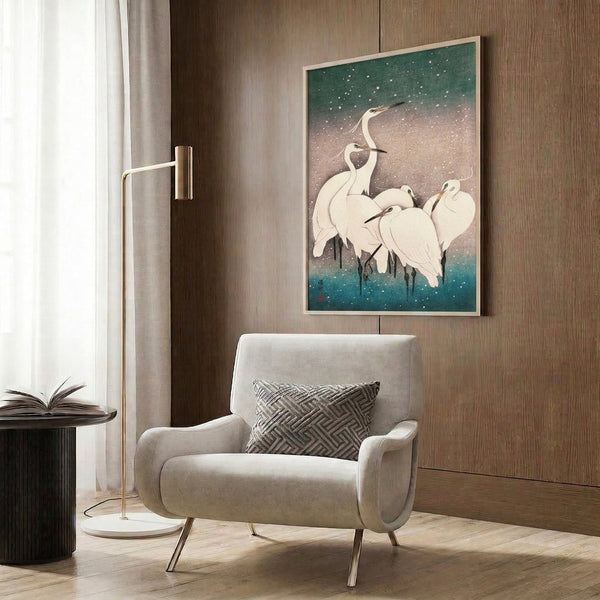 Elegant poster of snow-covered cranes in the style of Japanese woodblock art, featuring peaceful composition in soft sage, slate, teal, and white with gold accents framed on wall.