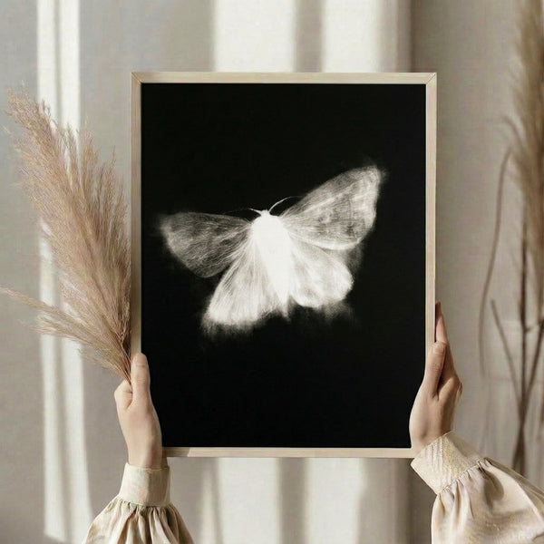 Contemporary line art print showcasing an elegant moth in cream and white tones on black, capturing a peaceful, introspective aesthetic.