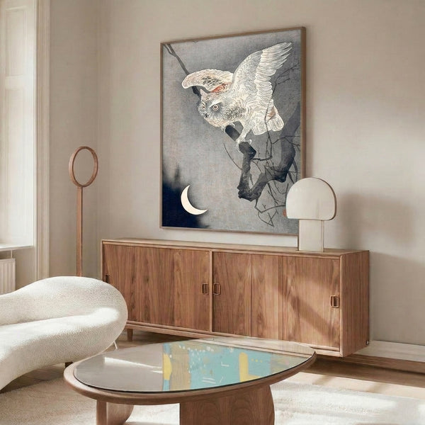 Framed owl print in traditional Japanese woodblock technique, showing the nocturnal bird perched with a crescent moon above, utilizing a moody palette of deep blues, grays, and cream tones.