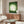 Tranquil white peacock woodblock art in muted cream and green palette, hung as a meditative Japandi-style print for peaceful home decor.