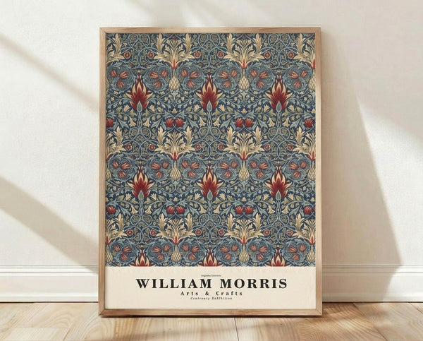 Deep teal and cream Arts and Crafts wallpaper pattern featuring ornate pomegranate and leaf motifs in rust red and gold, framed as a vintage art print on a wall.