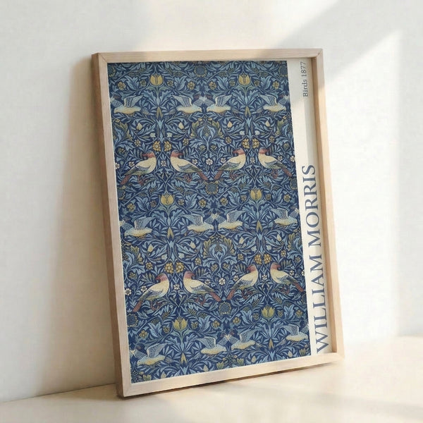 Nature-inspired Art Nouveau print displaying symmetrical bird and floral motifs in navy, terracotta, gold, and soft green on cream background.