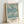 Framed botanical wall art with flowing floral motifs in cream, sage, and teal, embodying the elegant Art Nouveau style of classic cotton print design.