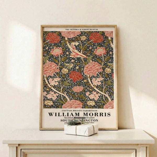 Framed William Morris cotton print poster featuring intertwining peonies and leaves in warm coral and dusty rose against deep charcoal and cream ground.