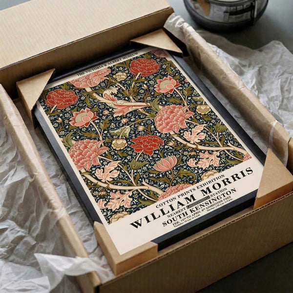 William Morris cotton print exhibition poster featuring naturalistic yet ornate peonies and climbing vines rendered in charcoal, rose, olive, and cream hues.