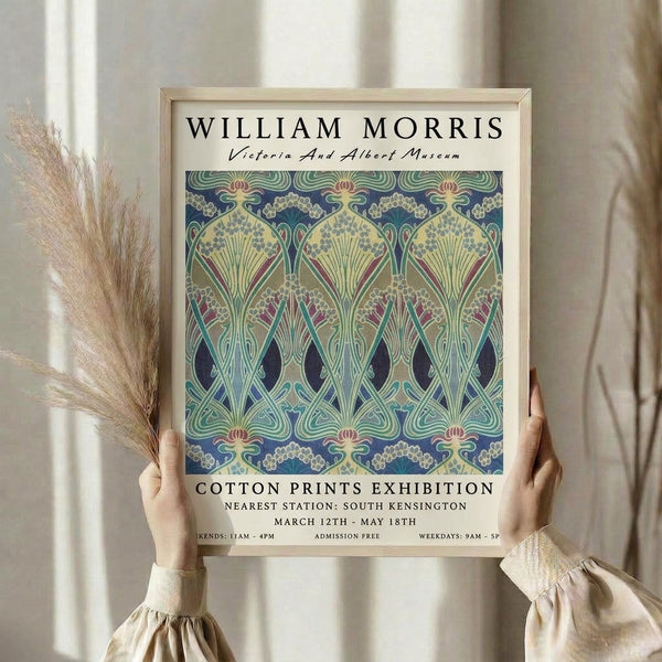 Vintage William Morris-inspired decorative print with elegant floral and ornamental design in cream, golden yellow, and navy blue, framed on a gallery wall.