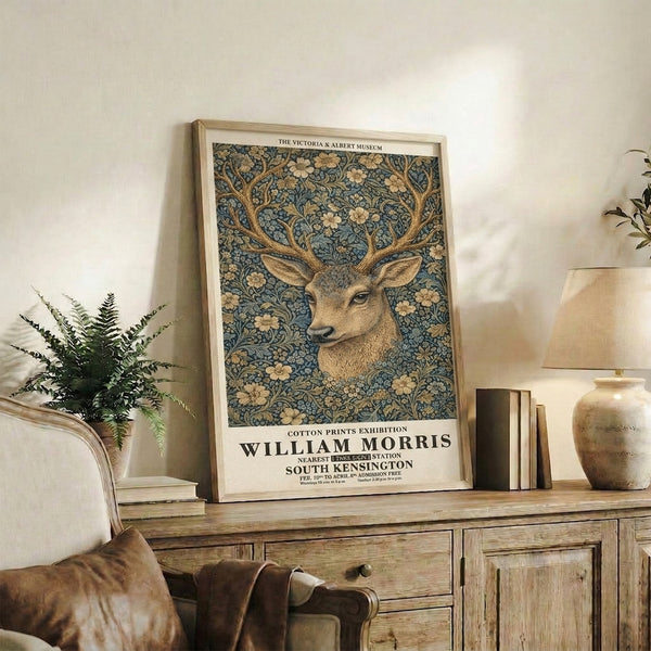 Vintage gallery-style print of a graceful deer surrounded by decorative botanical patterns in warm ochre and cool teal tones, Art Nouveau aesthetic.
