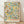 Art Nouveau botanical print featuring pomegranates, lemons, and flowering branches with ornamental leaves in forest green, golden yellow, and rust tones on cream background.