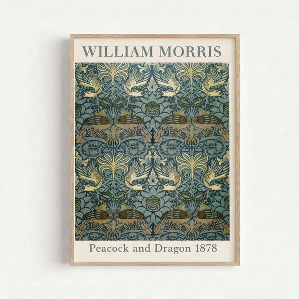 Vintage William Morris-inspired wall art depicting a decorative peacock with dragon motif surrounded by flowing leaves and flowers in sage green and dark blue.