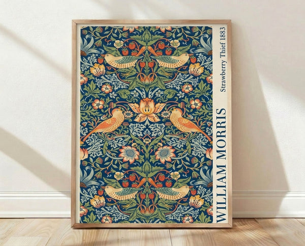 Art Nouveau framed poster featuring William Morris's 1883 Strawberry Thief design with birds among lush strawberry plants, flowers, and leaves in rich dark blue, sage green, coral, and cream tones.