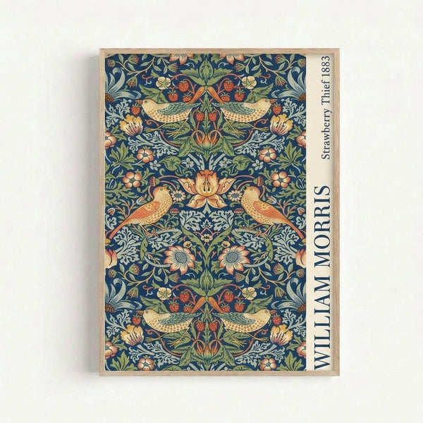 Vintage art print on wall showing Morris's naturalistic pattern of thrushes gathering strawberries amid ornamental foliage in harmonious blues, greens, and warm coral hues.