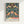 Vintage Art Nouveau poster with intricate strawberry and floral pattern in cream, golden orange, and deep blue tones, inspired by nature with classical elegance.