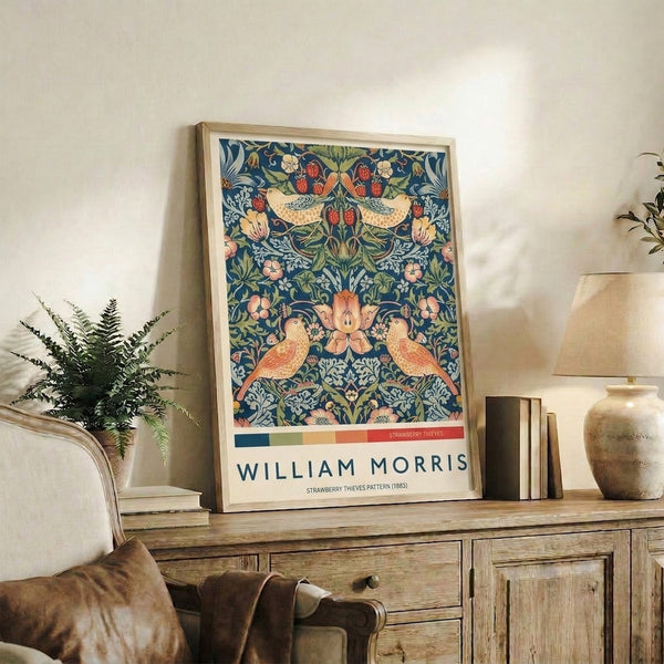 Nature-inspired William Morris print rendered in romantic jewel tones of navy, sage green, and warm coral featuring ornamental birds and strawberry plant motifs.