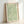 Framed poster art showing intricate willow leaves and graceful branches in calming sage and olive hues against a cream ground, Art Nouveau style.