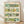 Playful modern line art poster featuring hand-drawn wine bottles in forest green, cream, orange, and yellow with bold black outlines, framed on a wall.