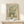 Winter cottonwood trees rendered in gentle watercolor with cream, soft gray, and pale yellow hues, framed on wall in serene, minimalist composition.