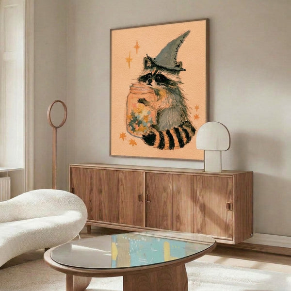 Enchanting watercolor print depicting a magical raccoon character wearing a pointed witch hat with stars and potion jar elements, featuring warm peachy and sage green hues against a creamy backdrop.