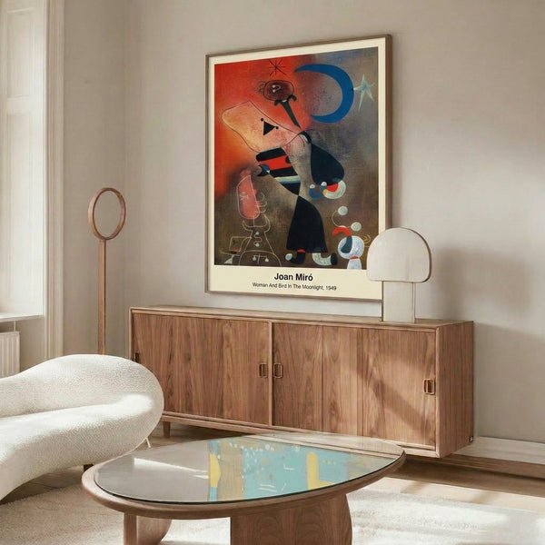 Surreal framed artwork depicting a woman and bird in nocturnal landscape with moon and stars, rendered in bold abstract style with deep blues, bright yellows, and red accents.