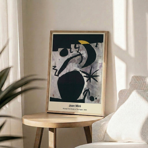 Framed abstract night scene featuring a woman and birds as dreamlike figures with flowing shapes in a sophisticated palette of blue, black, white, and ochre tones.