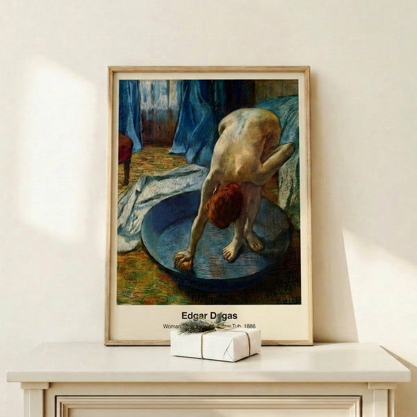 Intimate impressionist scene of a woman bathing, framed as wall art with gentle tonal palette of pale blues, creams, and soft grays.