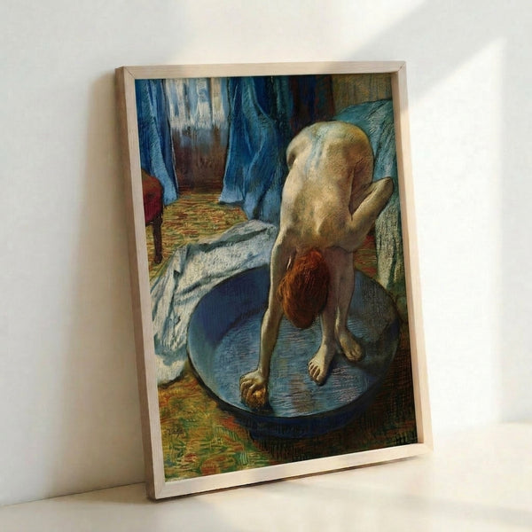 Framed poster of an impressionist bathing scene in soft, naturalistic tones, depicting a woman in a shallow tub with the gentle mood characteristic of classical interior studies.