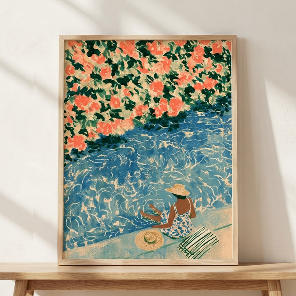Art Nouveau framed poster of a woman in a wide-brimmed hat beside a pool, shaded by vibrant coral-pink bougainvillea blooms, with deep teal water and cream accents creating a romantic vintage coastal escape.