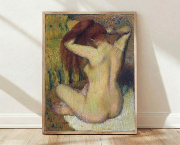 Framed poster of a woman combing her hair in soft impressionistic style, featuring warm earth tones and delicate brushwork in the manner of Degas.