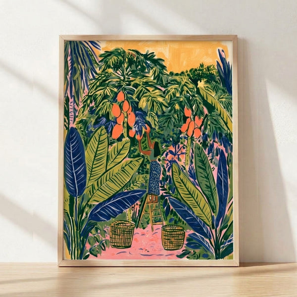 Framed boho art print featuring a peaceful woman harvesting ripe mangoes from a lush tree, surrounded by verdant foliage and holding a woven basket, rendered in warm yellows, forest greens, coral oranges, and dusty pinks.