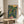 Japandi-style poster depicting a serene domestic harvest scene with a figure among flourishing mango trees and botanical elements, painted in a modern palette of warm earth tones, navy, and vibrant greens.