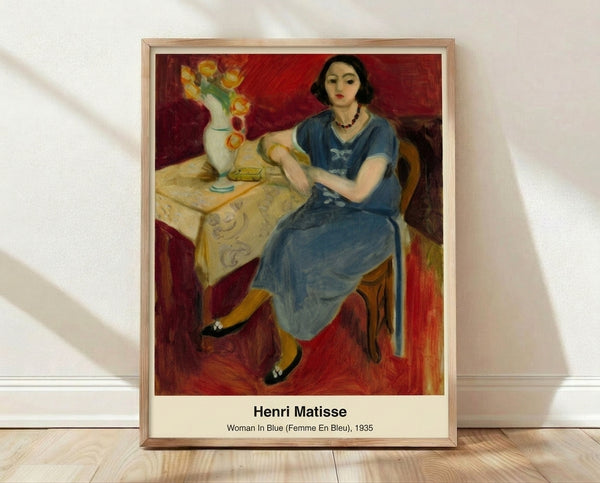 Framed Matisse-inspired abstract portrait of a woman in shades of blue and ochre with minimalist linework, conveying serene elegance on a gallery wall.