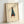 Vintage-style portrait of an elegantly dressed woman in a teal coat, brown accessories, and classic silhouette, minimalist poster with timeless aesthetic.
