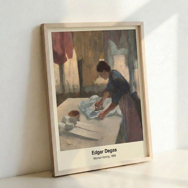 Vintage Impressionist framed print showing a woman absorbed in her ironing task, painted in soft ochre and cream with subtle green accents, evoking quiet domestic contemplation.