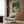 Minimalist home decor art featuring a serene reader with botanical and lifestyle accents, blending modern design with warm, inviting forest green and cream hues.