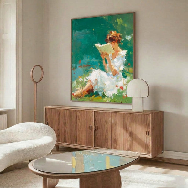 Wall art print of a peaceful moment: woman engrossed in reading within a flowering garden, rendered in impressionistic style with luminous teal, sage green, and burnt orange tones.